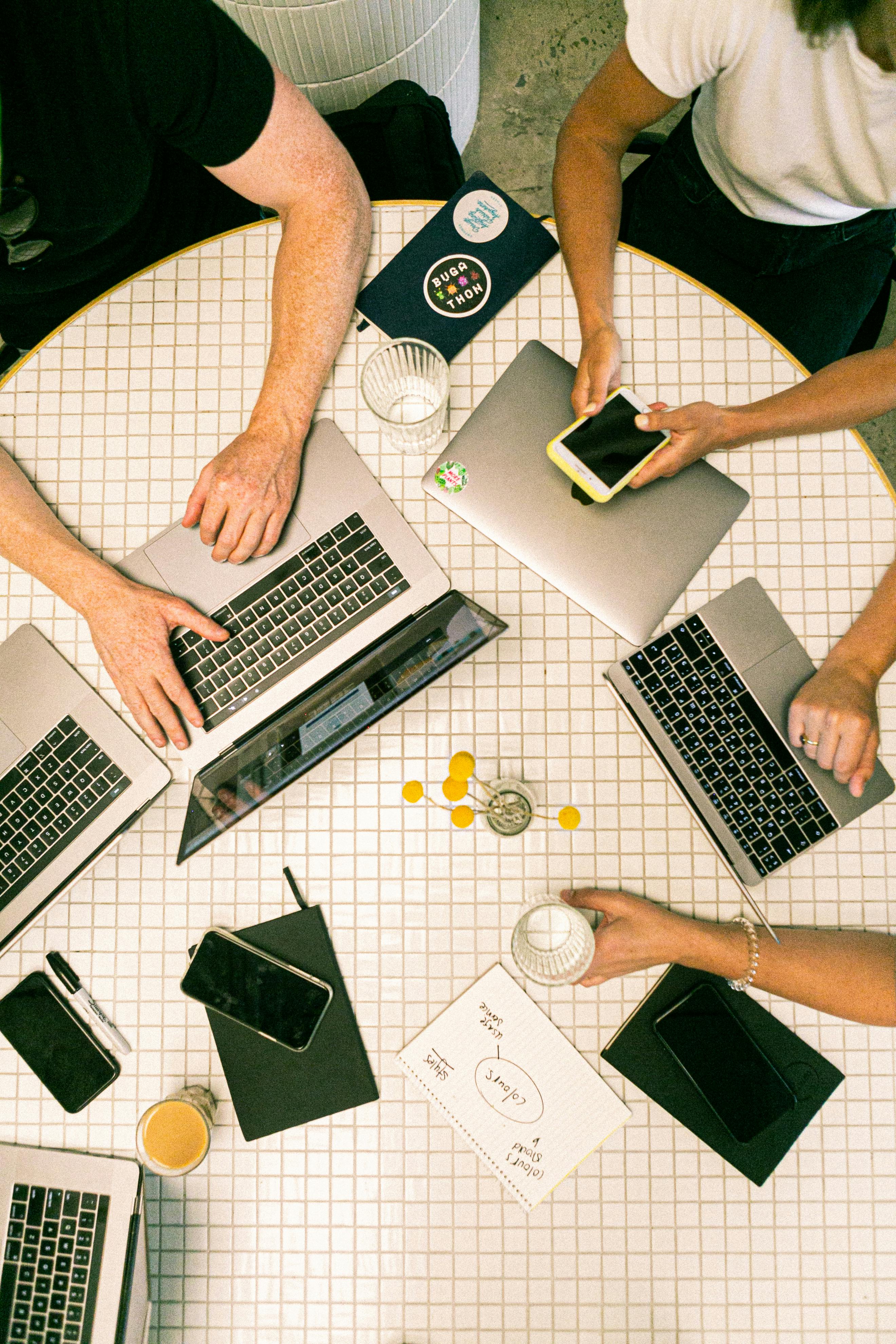 Collaborative workspace with people working on laptops representing business productivity